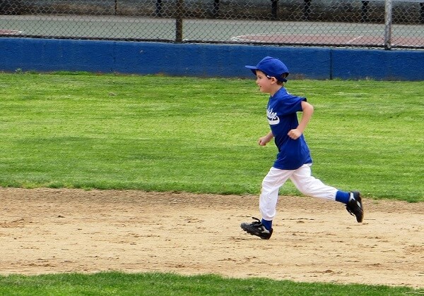 Kid Wearing Baseball Cap While Running Bases